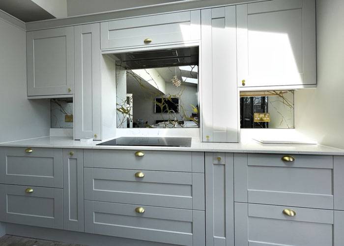 gold patterned mirror in grey shaker style kitchen