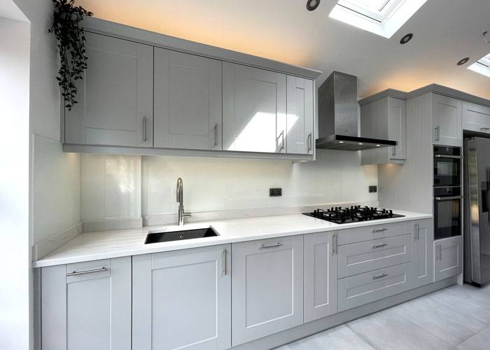 white classic glass splashback in grey shaker style kitchen